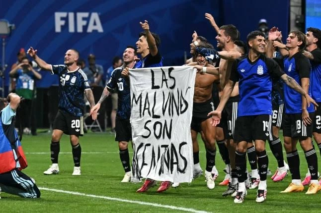 Argentina players hold a banner referencing the Falkland Islands after the World Cup semifinal against England.