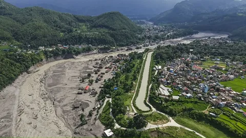 Rescue workers searching debris after Nepal Tibet border flash flood disaster