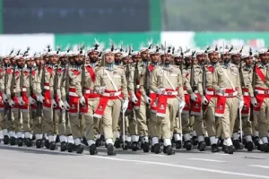 Pakistan military rank in 2026 showing Pakistan Army soldiers during a military parade with modern defense equipment and national flag in the background.